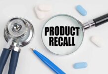 Stethoscope, pills, pen, magnifying glass with Product Recall.