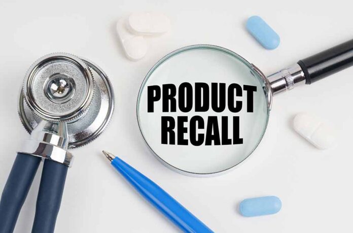 Stethoscope, pills, pen, magnifying glass with Product Recall.