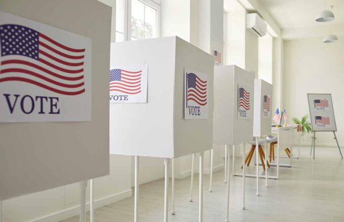 Voting booths with American flag signs.