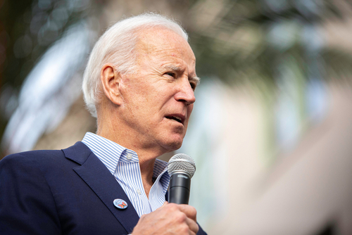 2020,Presidential,Candidate,Joe,Biden,,Speaks,During,An,Event,On A man in a suit speaking into a microphone at an outdoor event