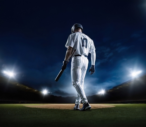 Baseball,Batter,Walking,Up,To,Home,Plate,At,A,Baseball A baseball player standing on the field at night, holding a bat