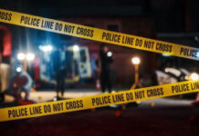 Federal Raid Turns Deadly — FBI Steps In Yellow police tape at a nighttime crime scene.
