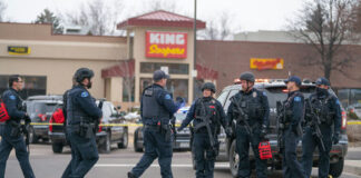 Police officers gathered outside King Soopers grocery store.
