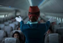 Sharia Law Showdown At 30,000 Feet Flight attendant giving safety demonstration in airplane aisle