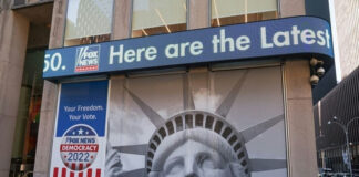 Facade with Statue of Liberty graphic and election-themed signage