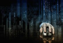 Hand on computer mouse over digital code background